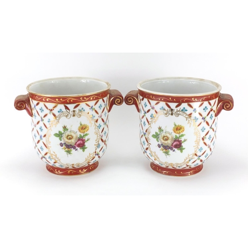 2072 - Pair of continental porcelain planters with twin handles, decorated with flowers, each 20.5cm high