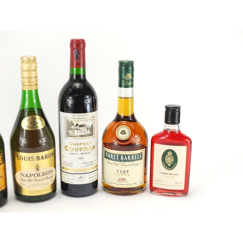 2123 - Six bottles of brandy and Medoc red wine including Louis Baron, Three Barrels and Charme