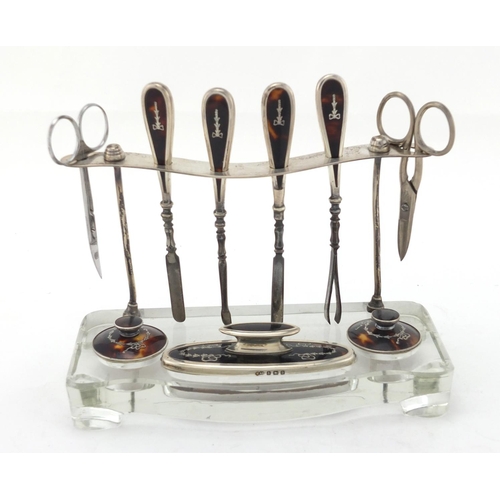 2464 - Silver and glass vanity stand with tortoiseshell tools, by Albert Carter, Birmingham 1926, 19cm wide