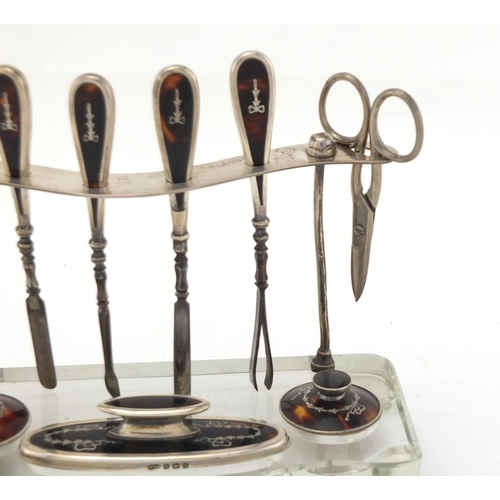2464 - Silver and glass vanity stand with tortoiseshell tools, by Albert Carter, Birmingham 1926, 19cm wide
