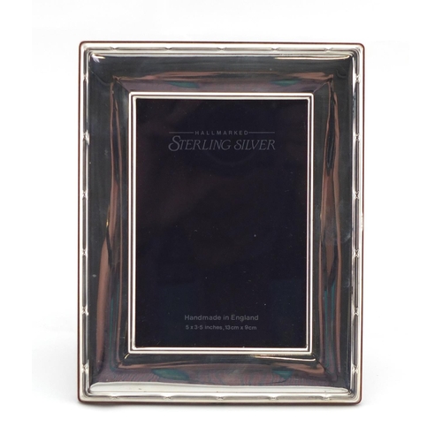 2492 - Rectangular silver easel photo frame with stylised border, by Carrs, boxed, 18cm x 14cm