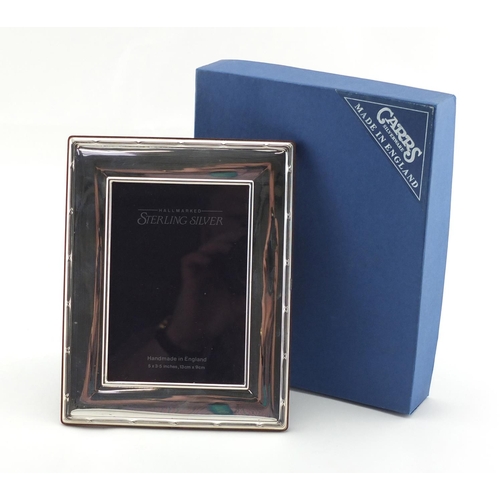 2492 - Rectangular silver easel photo frame with stylised border, by Carrs, boxed, 18cm x 14cm