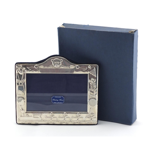 2463 - Rectangular silver easel photo frame embossed with teddy bears and toys, by Kitney & Co, boxed, 15cm... 