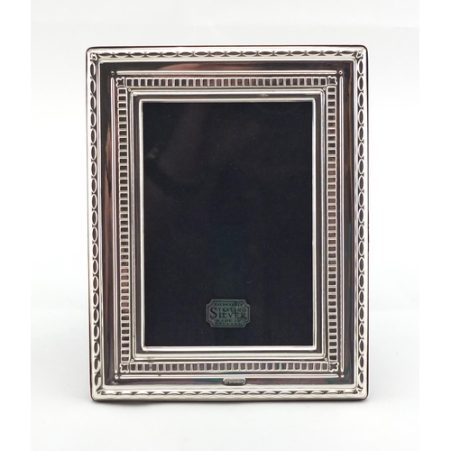 2482 - Rectangular silver easel photo frame, with stylised border, by Carrs, boxed, 18cm x 14cm