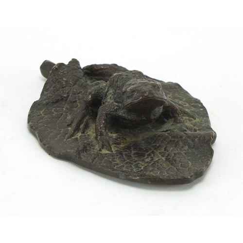 2057 - Patinated bronze model of a toad on a leaf, 12.5cm wide