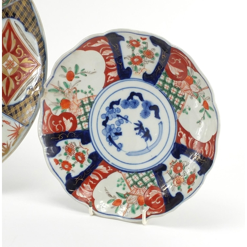 2176 - Three Japanese imari porcelain plates each hand painted with panels of flowers, the largest 31cm in ... 