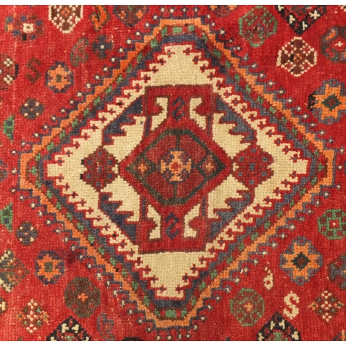 2010 - Rectangular Persian rug having an all over geometric motifs onto a predominantly red ground, 241cm x... 