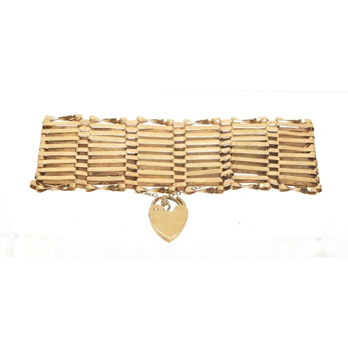 2619 - 9ct gold ten row gate bracelet, with love heart shaped padlock, 3.5cm wide, approximate weight 18.0g