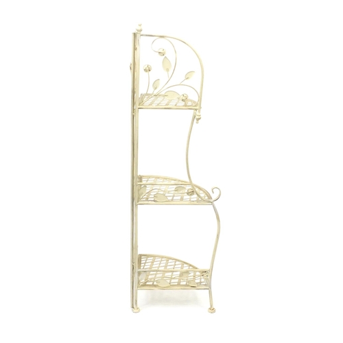 121 - Folding painted metal three shelf corner stand, 122cm high