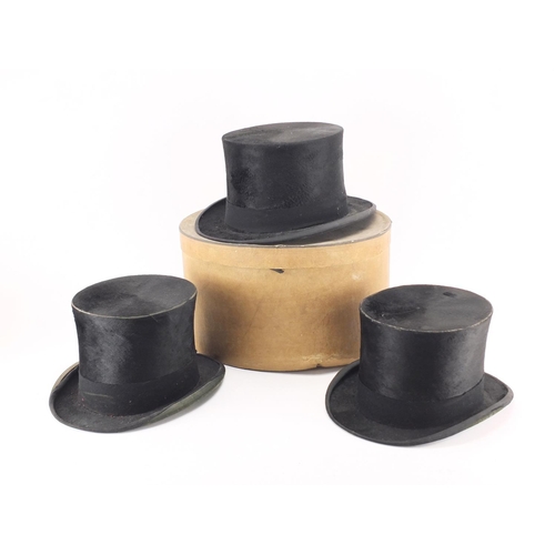 2439A - Four top hats comprising examples by Lock & Co, Dunn & Co and Henry Heath Limited, on with box
