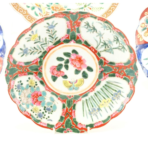 2190 - Three Japanese porcelain plates and a shallow dish, finely hand painted with flowers and birds of pa... 