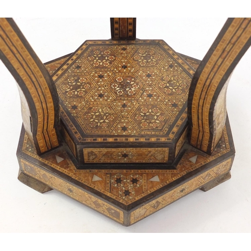 2025 - Moorish design circular topped occasional table, with hexagonal stepped base, having a geometric par... 