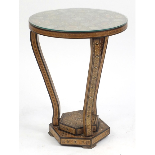 2025 - Moorish design circular topped occasional table, with hexagonal stepped base, having a geometric par... 