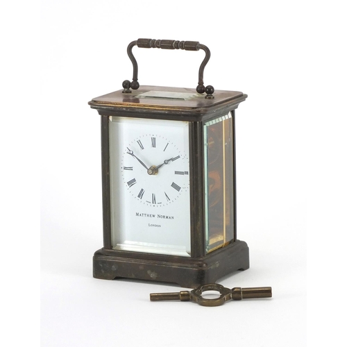 2084 - Brass cased carriage clock by Matthew Norman of London, with enamelled dial and Roman numerals, the ... 