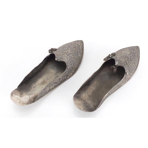 2499 - Pair of Middle Eastern unmarked silver slippers, embossed with foliate motifs, each 17cm in length, ... 