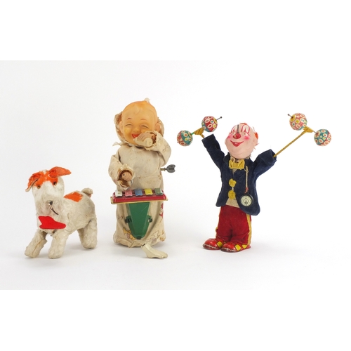 2259 - Three vintage tinplate toys including a Japanese baby playing a xylophone, the largest 22.5cm high