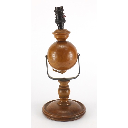 2314 - Carved wooden gimbal lamp with Bakelite fitting, 37cm high
