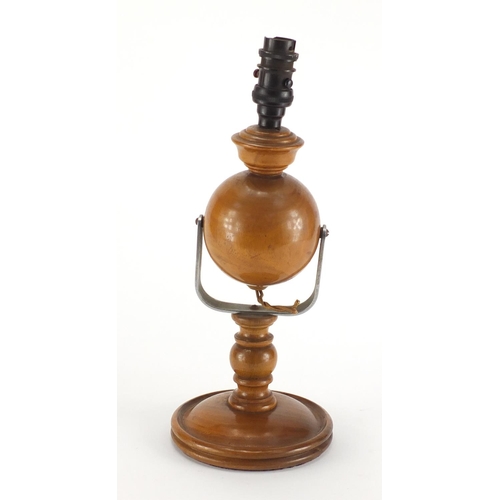 2314 - Carved wooden gimbal lamp with Bakelite fitting, 37cm high