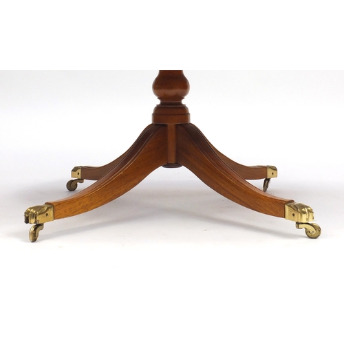 102 - Yew oval coffee table, with  brass paw feet, 51cm H x 121cm W x 69cm D