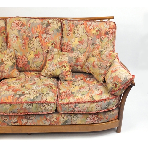 2 - Ercol Renaissance three seater settee, with floral upholstered lift off cushions, approximately 190c... 