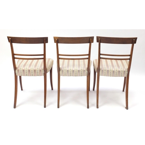 7 - Set of six Regency mahogany dining chairs, with carved top rails and striped upholstered stuff over ... 