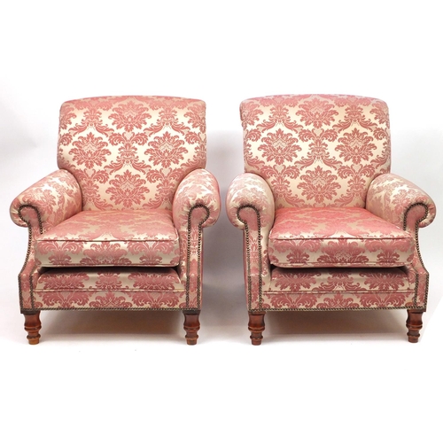 16 - Pink floral upholstered three seater settee and two matching armchairs, the settee 180cm wide