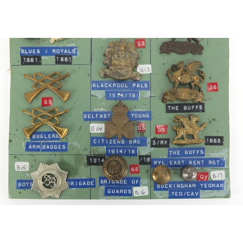1039 - Sheet of Military interest cap badges and buttons  including Buglers Blackpool Pals and The Buffs