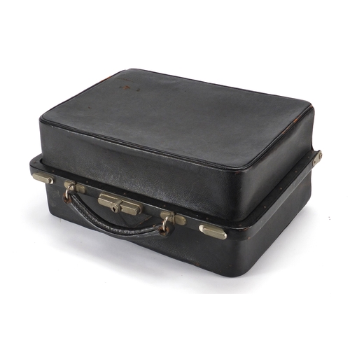 2224 - Vintage black leather vanity case, housing glass bottles with silver plated lids and ebonised handle... 