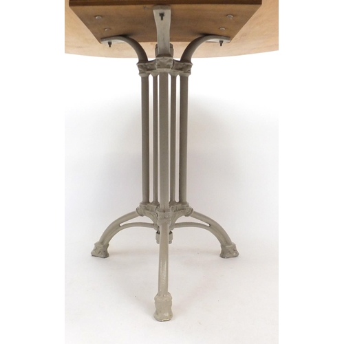 14 - Circular maple dining table, with cast iron base, 76cm high x 120cm in diameter
