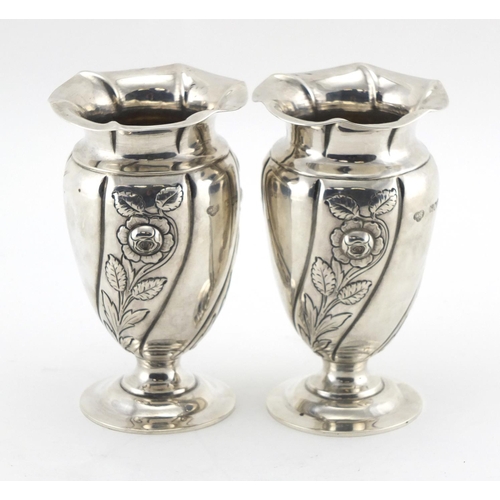 616 - Pair of Art Nouveau silver pedestal vases, embossed with stylised flowers, by Gibson & Co Ltd London... 
