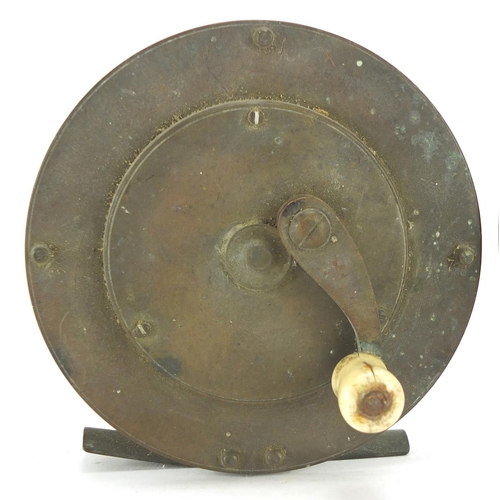 128 - Two fly fishing reels comprising a Victorian 4.5inch brass example with ivory handle and The Conques... 