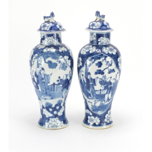 321 - Pair of Chinese blue and white baluster vases and covers, each hand painted with figures and Prunus ... 