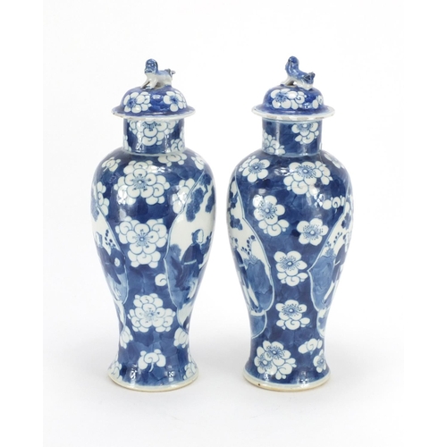 321 - Pair of Chinese blue and white baluster vases and covers, each hand painted with figures and Prunus ... 