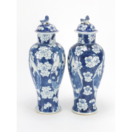 321 - Pair of Chinese blue and white baluster vases and covers, each hand painted with figures and Prunus ... 