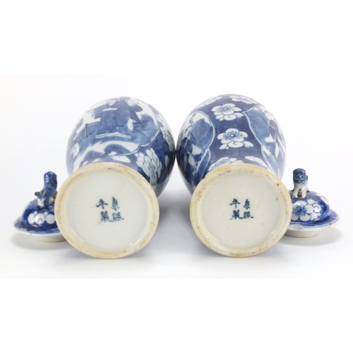 321 - Pair of Chinese blue and white baluster vases and covers, each hand painted with figures and Prunus ... 