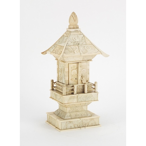 413 - Chinese carved ivory pagoda enclosing a figure of Buddha, 25.5cm high