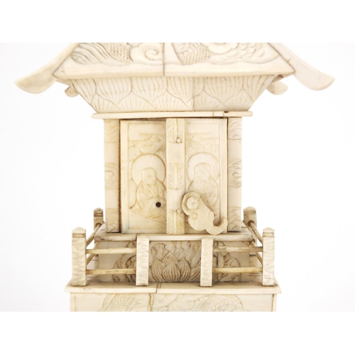 413 - Chinese carved ivory pagoda enclosing a figure of Buddha, 25.5cm high