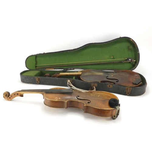 26 - Two old wooden violins, one with bow and carrying case, one violin with one piece back the other bea... 