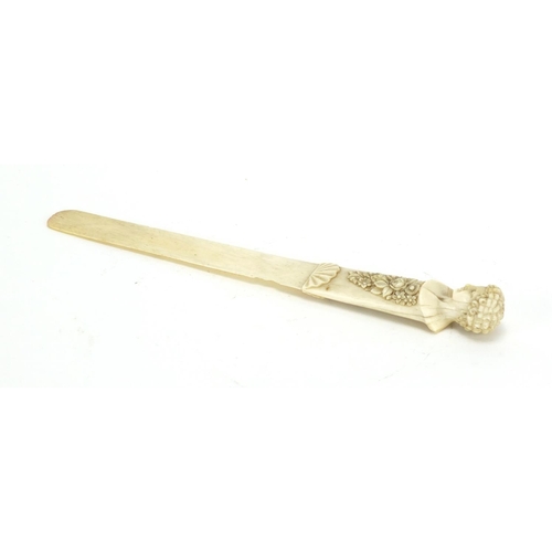 7 - 19th century ivory page turner, the handle finely carved with a classical bust and flowers, 26cm in ... 