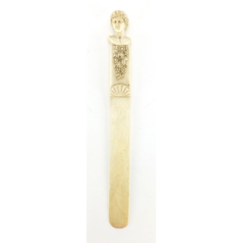 7 - 19th century ivory page turner, the handle finely carved with a classical bust and flowers, 26cm in ... 