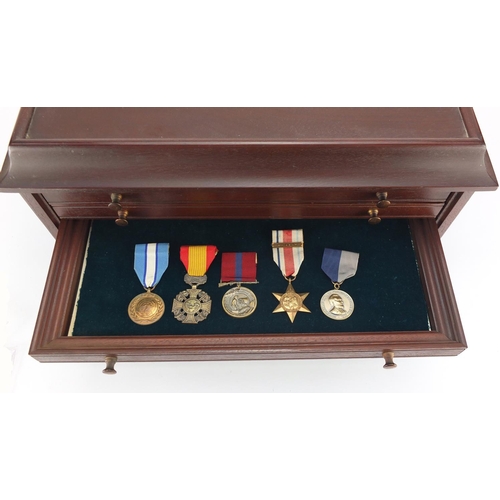 213 - Military interest medals, awards and badges arranged in a collectors chest including World War II St... 