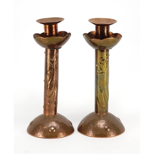 569 - Pair of Arts & Crafts copper candlesticks by Newlyn, each embossed with three stylised fish, impress... 