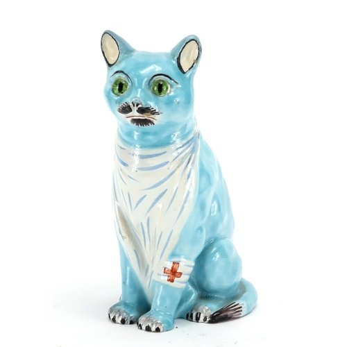 555 - Mosanic faience pottery model of a seated cat with beaded eyes, 24cm high