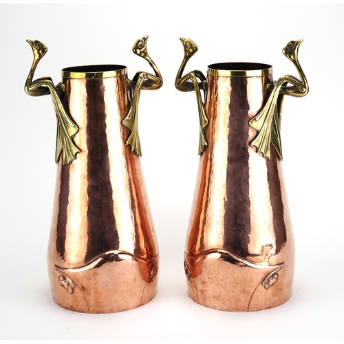 572 - Pair of German Arts & Crafts copper and brass vases with bird design handles and tapering bodies, ea... 