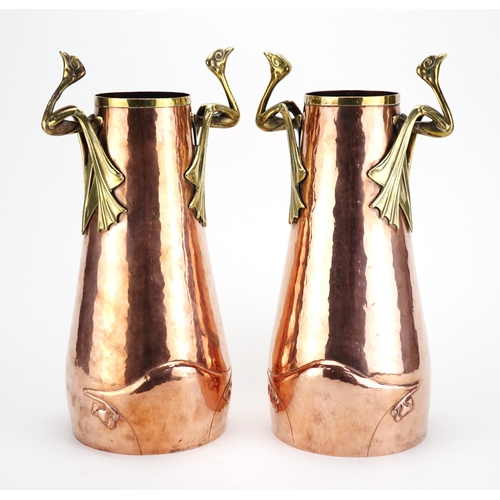 572 - Pair of German Arts & Crafts copper and brass vases with bird design handles and tapering bodies, ea... 