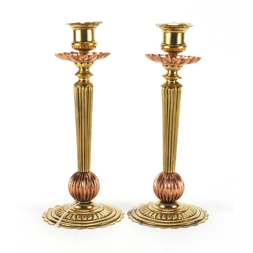 113 - Pair of Arts & Crafts style brass and copper candlesticks, 22cm high