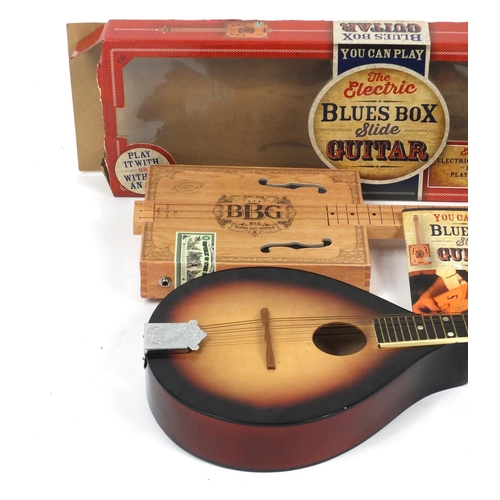 151 - Electric Blues Box Slide guitar and an eight string banjolele, the largest 65cm high