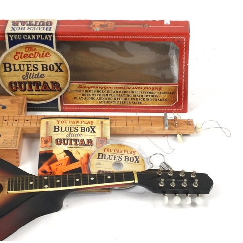 151 - Electric Blues Box Slide guitar and an eight string banjolele, the largest 65cm high