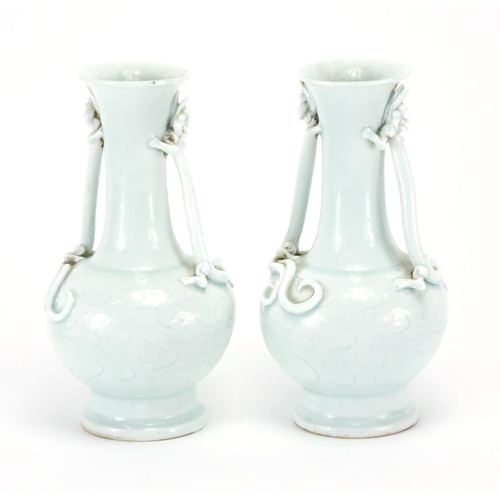 335 - Pair of Chinese celadon glazed vases, each with twin water dragon handles, the bodies incised with f... 