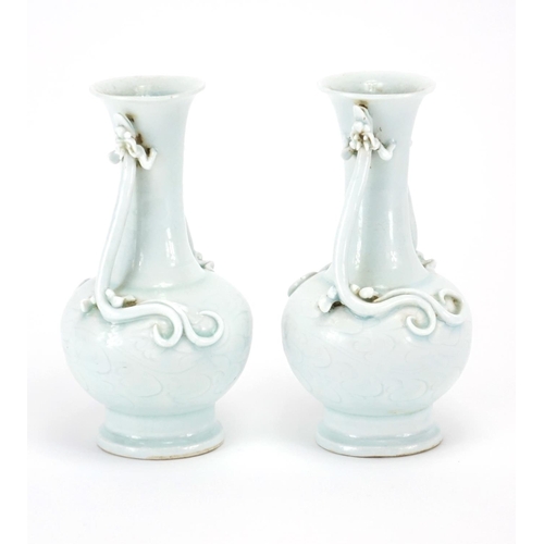 335 - Pair of Chinese celadon glazed vases, each with twin water dragon handles, the bodies incised with f... 